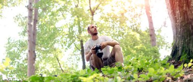 Genç bir fotoğrafçı doğada çekim yapmak için güzel bir yer arıyor.