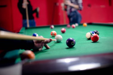 İnsanlar bilardo oynamaktan zevk alıyor.