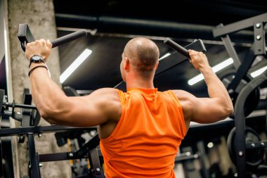 Adam sırt kası için egzersiz yapıyor.