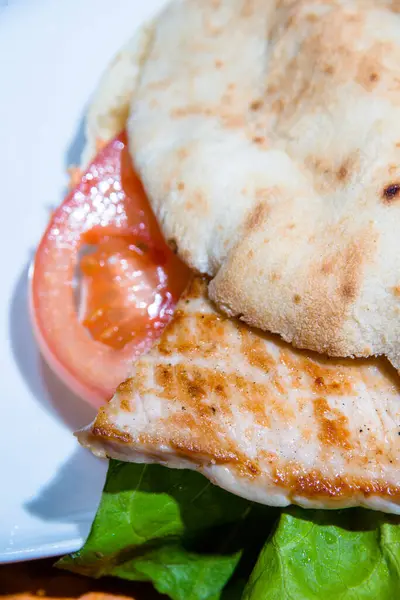 stock image Close up of burger with grilled chicken, full frame.