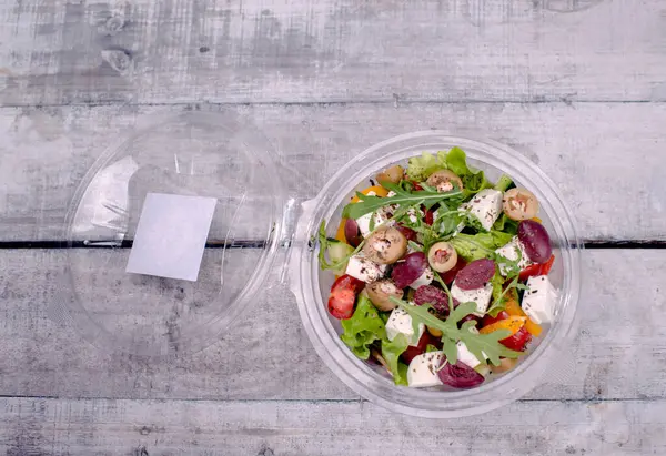 Akdeniz salatası gri arka planda açık kasede.