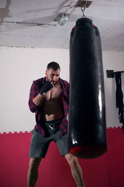 Boxer training alone in underground gym