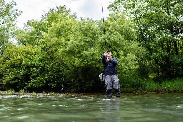 Erkekler yazın nehir kenarında balık tutmayı severler.