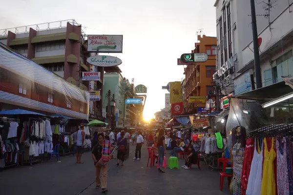 Khao San Road with random people and hotels on the side. With market and shops while Sunset . High quality photo