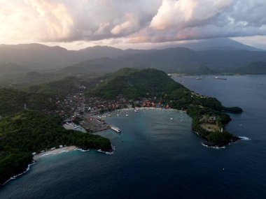 Doğu Bali Endonezya 'daki Padang Bai Limanı' nın yatay görüntüsü. Agung volkanının arka planında bulutlar ve günbatımı. Yüksek kalite fotoğraf