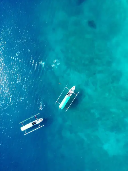 stock image Two Jukung Traditional Asian Fisherboat or also diving. Top down aerial View with beautiful reef underneath. High quality photo