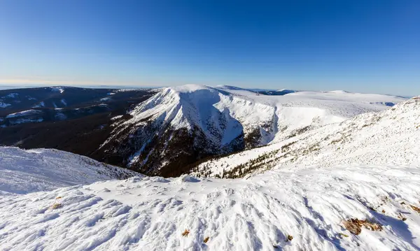 Kar ve açık mavi gökyüzü ile kış dağı manzarası. Panoramik manzara. Dev dağlar..