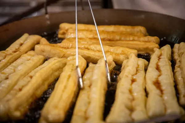 stock image Frying Chinese Donuts as Street Food called youtiao