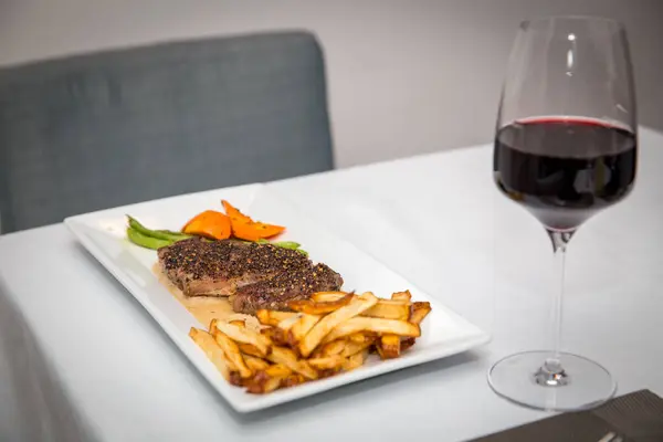 Steak and Fries with red wine for dinner