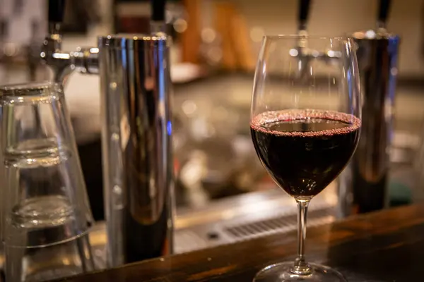 Glass of red wine on a bar