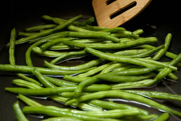 Sauteed Green Beans on the stove in oil