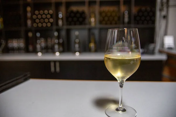 Glass of white wine with a dark background