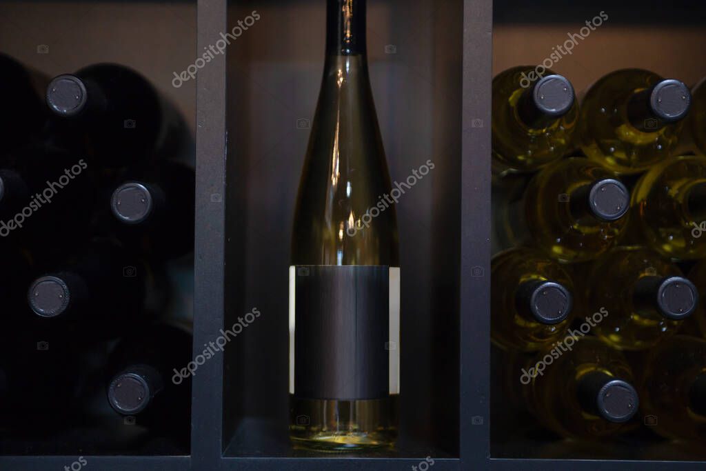 Unlabled White Wine bottles in racks