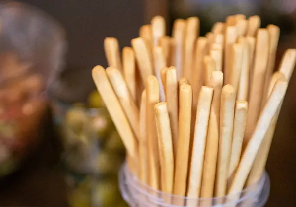 A bunch of bread sticks that will be used for various dips