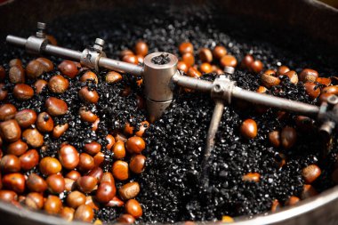 Kızarmış Kestaneler kömürle pişiriliyor.