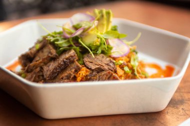 Çeşitli soslu dilimlenmiş biftek.