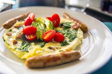 Fritattas with Tomatoes, spinach and Sausage clipart