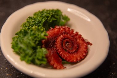 Coiled Octopus Sashimi in a ramekin clipart