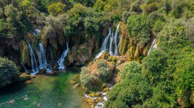 Waterfalls in nature. Water source of life, flowing water in a forest. Kravice waterfalls, Bosnia and Herzegovina. clipart