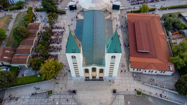 Medjugorje church aerial view, tourist place in Bosnia and Herzegovina. Prayer and faith for tourists and groups who are traveling to the city of Medjugorje. clipart