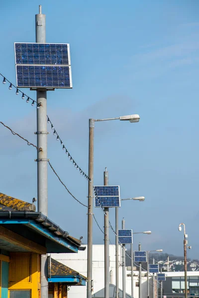 Solar panels on streetlight lamp posts. Portrait view.  Clean renewable energy with zero carbon emissions. Electricity generation from the sun. Solar energy. Copy space. sustainable climate visuals