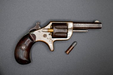 Exeter, Devon, uk. November 13th 2022. Colt new line pocket revolver. Vintage 1873 seven shot cylinder palm pistol. .22 bullet calibre. Compact firearm. clipart