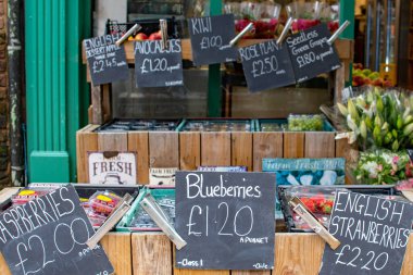 Manavda taze meyve ve sebze. Renkli taze çiftlik yiyeceklerinin ahşap kasalarda sergilenen canlı ve davetkar görüntüsü.. 