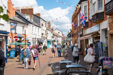 Sidmouth, Devon, uk. 06-06-24. Sidmouth high treet with shoppers and tourists browsing this popular seaside town.  clipart