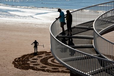 Torquay, Devon uk. 09-17-24. Beach sand art at Torquay in Devon. Torre Abbey sands with the seafront behind.  clipart