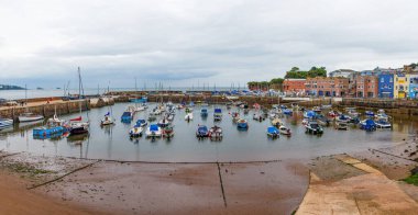 Paignton, Devon, uk. 09-27-24. Paignton harbour showing the sea wall and boats. Colourful image. Torbay and English Riviera clipart