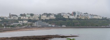 Torquay, Devon, uk. 10-15-24. Torquay seafront misty winter panorama image. English riviera with cafe's, bars. Torquay marina with boats and yachts . Princess theatre. clipart