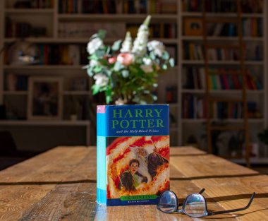 Torbryan, Devon, uk. 10-26-24. Harry Potter and the half blood prince, by J K Rowling. The picture is set against a softly focused bookcase background. Selective focus on the front cover. clipart