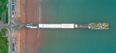 Paignton pier in Torbay aerial panoramic picture. A unique top down view showing the length of the pier from beach to sea. clipart