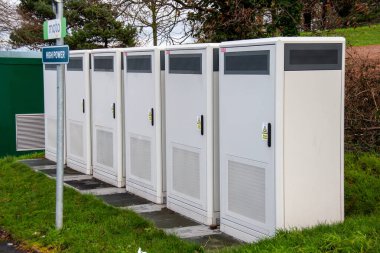 Exeter, Devon, uk. 01-06-25. Electric vehicle power transformers supplying power to EV charging stations. High voltage power supply. Electric vehicle charging. Tesla. clipart