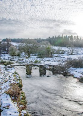 Dartmoor winter snow scene showing Postbridge in the Dartmoor national park.  clipart