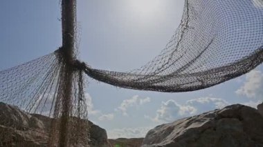 old fishing nets blowing in the wind and blue sky