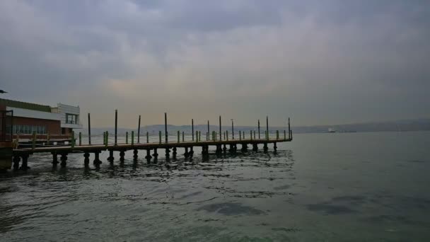 Long Pier Extending Sea Mountains Cloudy Weather — Stock Video
