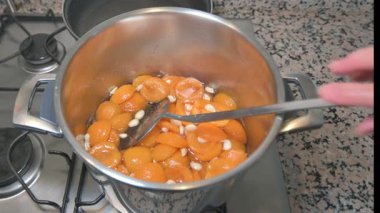 Apricot jam is boiling in the pot