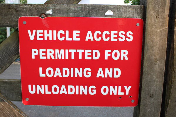 Red Sign with White text "Vehicle Access Permitted for Loading and Unloading Only"