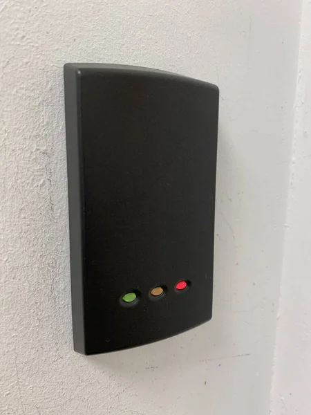 Picture of a door access system mounted on a white wall