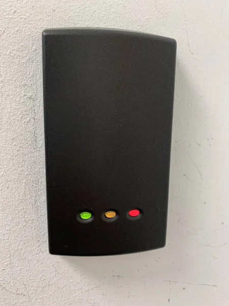 Picture of a door access system mounted on a white wall