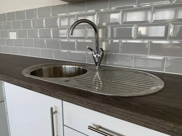 Picture of a modern metal kitchen office sink and countertop