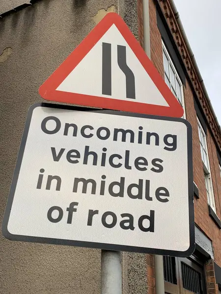 Road sign warning drivers that oncoming vehicles will be in the middle of the road UK