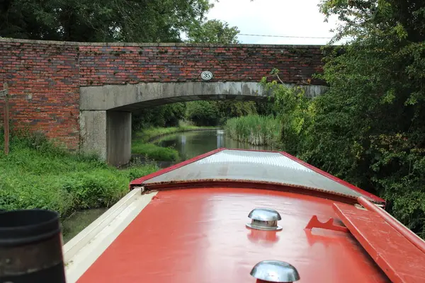 Narrow boat on a canal with bridge ahead, Picture taken from boats point of view