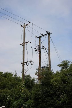 İngiliz 11KV elektrik hattı ahşap direklere basamaklı trafo aşağı iniyor.