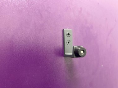 Mor bir duvara monte edilmiş küçük bir armatürün yakın çekimi