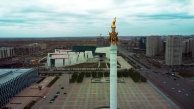 Sonbaharda Astana Merkez Meydanı 'nın insansız hava aracı görüntüsü. Astana 'nın merkez meydanının üzerinde süzülen bu drone videosu görkemli stella' yı bir kartalla, şehir binalarının, hareket eden araçların ve diğer yerlerin ortasında, yumuşak sonbahar ışığı altında yakalıyor..