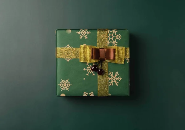 Top view of green Christmas box on green background
