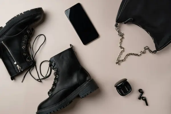 Stock image Total black accessories on beige background. Flat lay, top view.