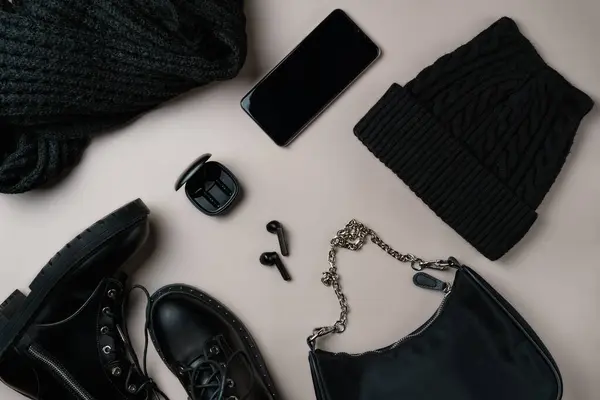 stock image Total black accessories on beige background. Flat lay, top view.